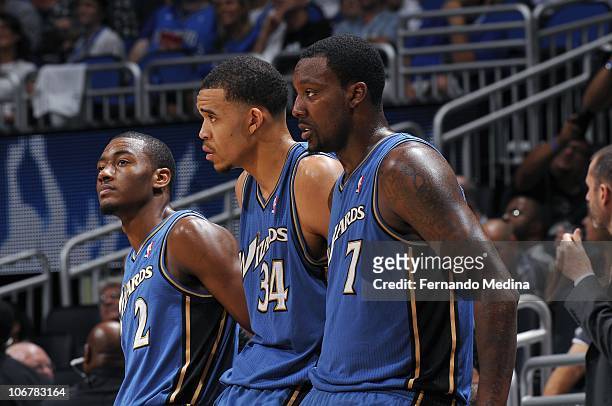 John Wall, JaVale McGee and Andray Blatche of the Washington Wizards stand on the sideline during a game against the Orlando Magic on October 28,...