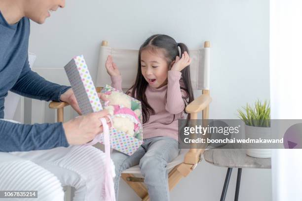 dad gives children gifts. - giving a girl head fotografías e imágenes de stock