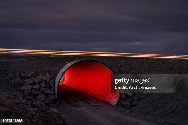 small tunnel at night. - red light stock-fotos und bilder