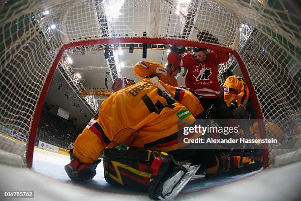 Dennis Endras, goalie of Germany safes a shot by Eric Schneider of Canada during the German Ice Hockey Cup 2010 first round game between Germany and...