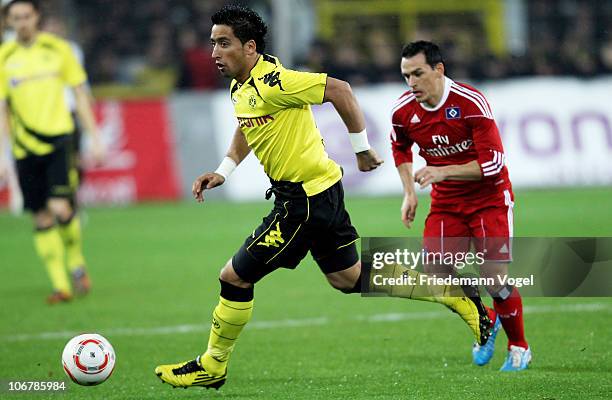 Lucas Barrios of Dortmund and Piotr Trochowski of Hamburg battle for the ball during the Bundesliga match between Borussia Dortmund and Hamburger SV...