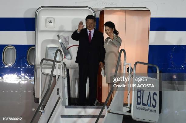 China's President Xi Jinping and his wife Peng Liyuan wave upon landing at the airport in Panama City, on December 2, 2018. - Chinese President Xi...