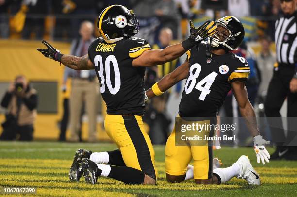 James Conner of the Pittsburgh Steelers celebrates with Antonio Brown after a 1 yard rushing touchdown during the first quarter in the game against...