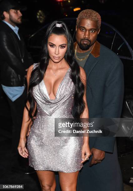 Kim Kardashian is seen wearing a Versace dress with Kanye West outside the Versace Pre-Fall 2019 Collection on December 2, 2018 in New York City.