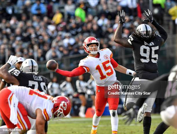 Kansas City Chiefs quarterback Patrick Mahomes throws under pressure from Oakland Raiders defensive end Fadol Brown late in the third quarter on...