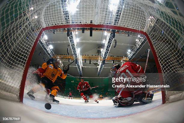 Patrick Hager of Germany celebrates the 4th team goal whilst Fred Brathwaite, goalie of Canada reacts during the German Ice Hockey Cup 2010 first...