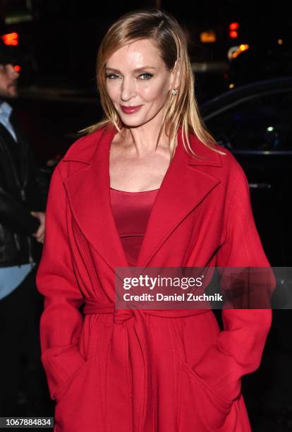 Uma Thurman is seen wearing a red coat outside the Versace Pre-Fall 2019 Collection on December 2, 2018 in New York City.