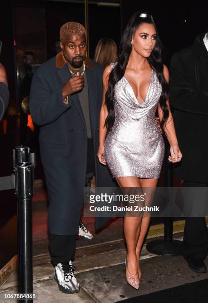 Kim Kardashian is seen wearing a Versace dress with Kanye West outside the Versace Pre-Fall 2019 Collection on December 2, 2018 in New York City.