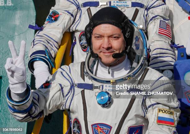 Russian cosmonaut Oleg Kononenko, a member of the International Space Station expedition 58/59, gestures as he boards the Soyuz MS-11 spacecraft...