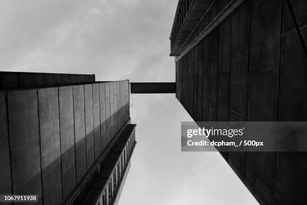 brutalist architecture against cloudy sky - brutalism stock pictures, royalty-free photos & images
