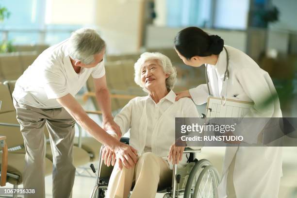 senior couple talking with doctor - the japanese wife stock pictures, royalty-free photos & images