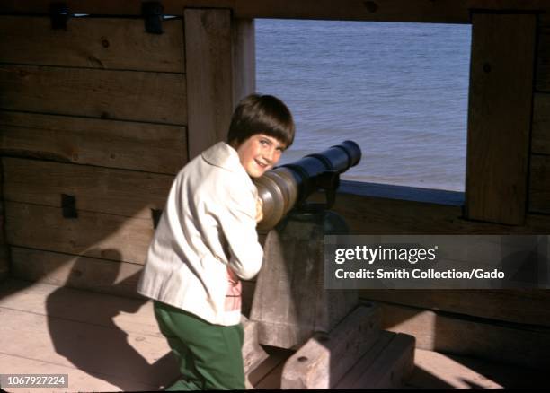 Young girl playing with a canon at a historical site at Fort Delaware, United States, 1968.