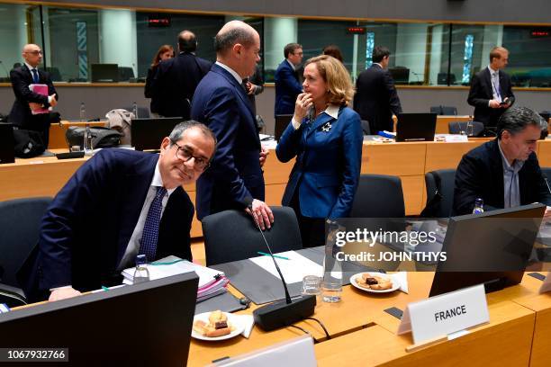 Italian Minister of Economy and Finance Giovanni Tria sits as German Finance Minister Olaf Scholz talks with Spain's Economy Minister Nadia Calvino...