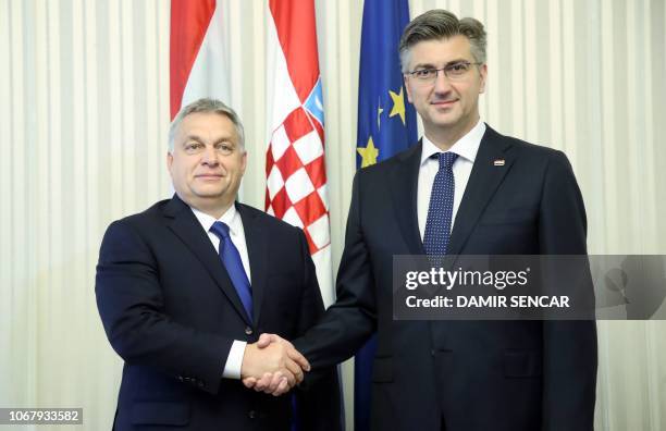 Croatian Prime minister Andrej Plenkovic shakes hands with his Hungarian counterpart Viktor Orban prior to their meeting in Zagreb, on December 3,...