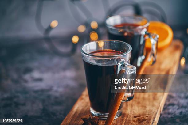 mulled wine with orange, cinnamon, star anise and spices for christmas - mulled wine stock pictures, royalty-free photos & images