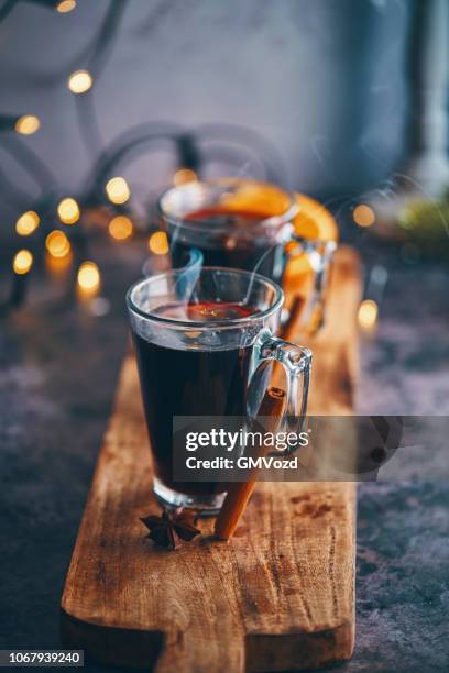 mulled wine with orange, cinnamon, star anise and spices for christmas - mulled wine stock pictures, royalty-free photos & images