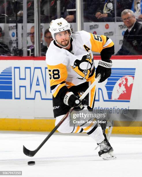 Kris Letang of the Pittsburgh Penguins takes the puck in the third period against the New Jersey Devils at Prudential Center on November 13, 2018 in...