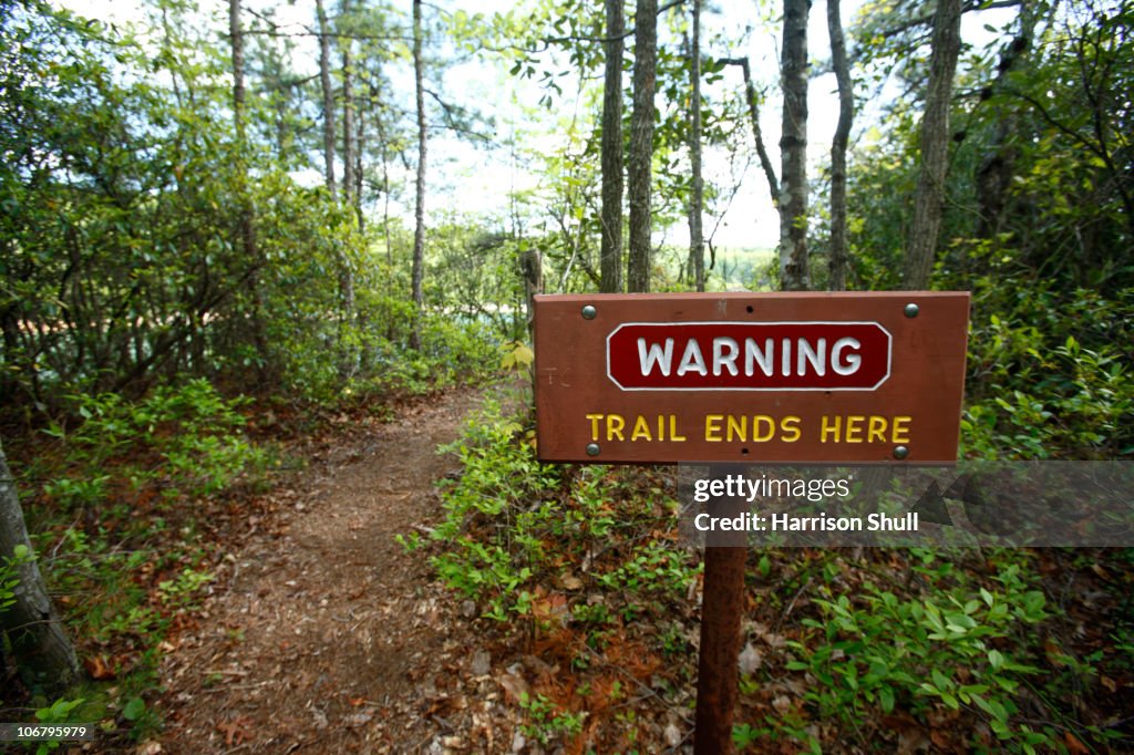 Trail warning sign reading