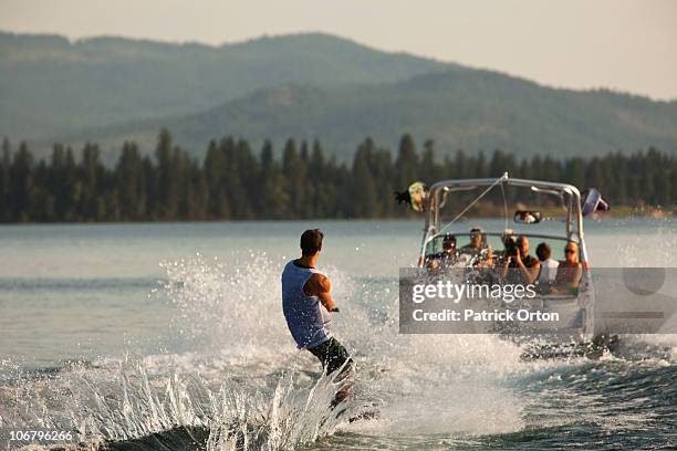 young man wakeboarding in idaho. - wakeboarding stock pictures, royalty-free photos & images