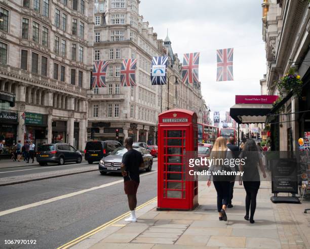red telephone box in the strand, london - the strand london stock pictures, royalty-free photos & images