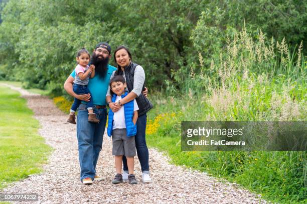 due bambini piccoli e i loro genitori che se ne andavano nella natura - family hiking in spring outdoors foto e immagini stock