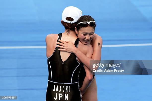 Mariko Adachi of Japan hugs teammate Akane Tsuchihashi of Japan after winning the gold and silver medals respectively in the Women's Individual...