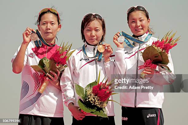 Yun Jung Jang of South Korea, Mariko Adachi of Japan and Akane Tsuchihashi of Japan pose with the medals won in the Women's Individual Triathlon at...
