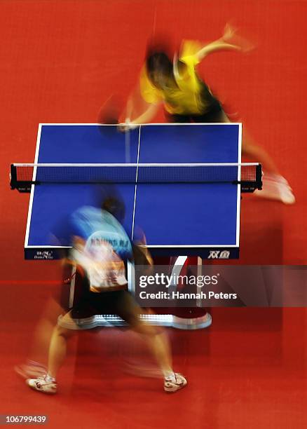 Xiaoxia Li of China competes against Nai-I Hsiung of Chinese Taipei in the Women's Team contest at the Gyangzhou Gymnasium during day one of the 16th...