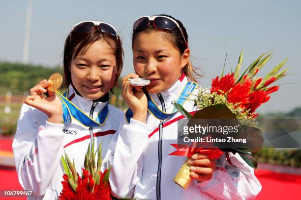 Mariko Adachi of Japan and Akane Tsuchihashi of Japan pose with the medals won in the Women's Individual Triathlon at the Triathlon Venue during day...