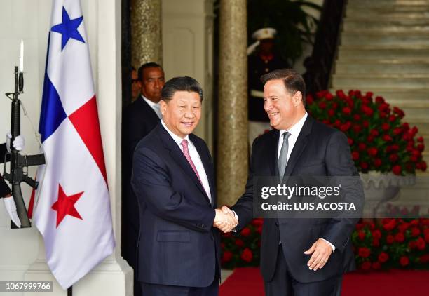 Panama's President Juan Carlos Varela and China's President Xi Jinping shake hands upon the latter's arrival at the presidential palace in Panama...