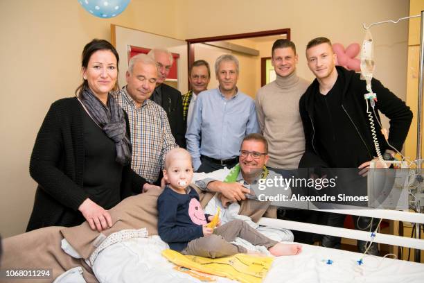 Marco Reus, Lukasz Piszczek and head coach Lucien Favre of Borussia Dortmund during the annual visit at the Children's Hospital on December 03, 2018...