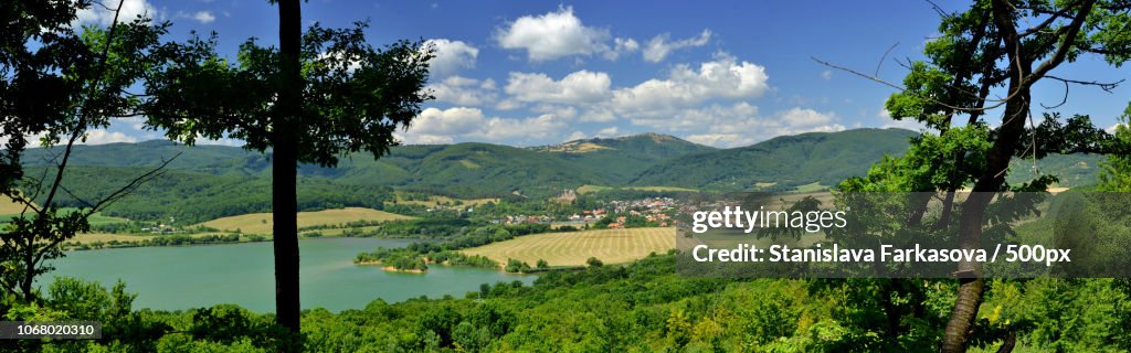 Panoramic view of valley with emerald lake and mountains