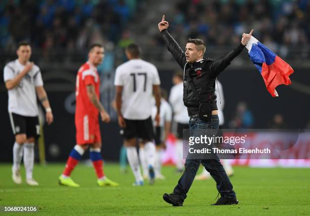 Streaker with a Russian flag runs on the pitch during the International Friendly match between Germany and Russia at Red Bull Arena on November 15,...
