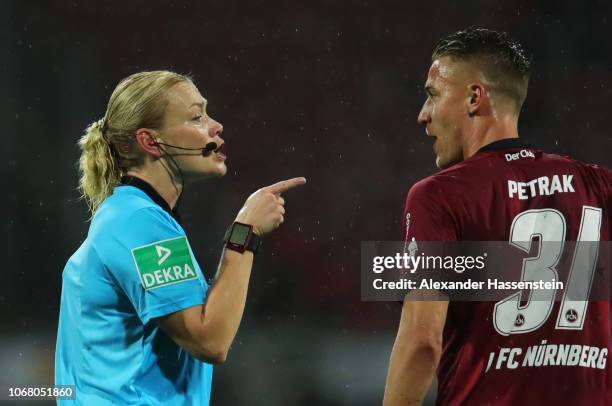 Referee Bibiana Steinhaus talks to Ondrej Petrak of Nuernberg during the Bundesliga match between 1. FC Nuernberg and Bayer 04 Leverkusen at...