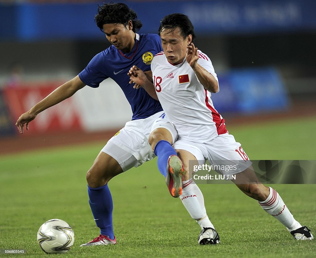 Zhang Jian of China battles for a ball against Omar Map of Malaysia ...