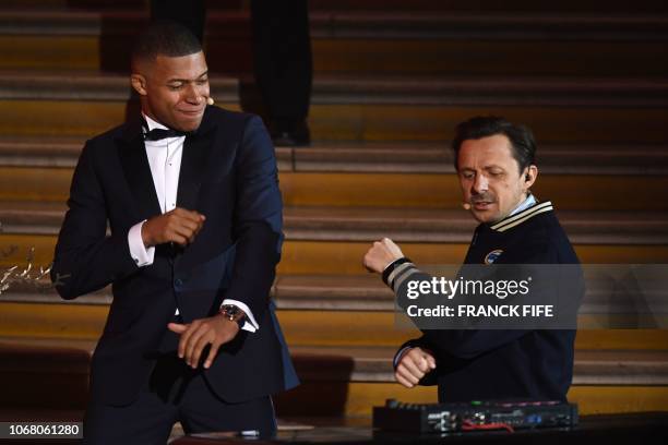 Paris Saint-Germain's French forward Kylian Mbappe dances with French DJ and producer Martin Solveig after receiving the Kopa Trophy during the 2018...