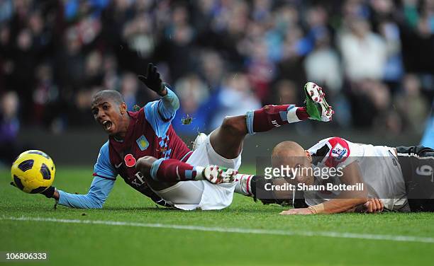Ashley Young of Aston Villa is bought down by Wes Brown of Manchester United for a penalty during the Barclays Premier League match between Aston...