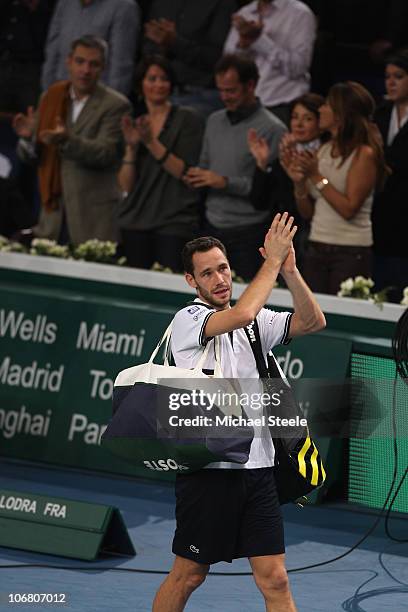 Michael Llodra of France walks off centre court after his 7-6,5-7,6-7 defeat against Robin Soderling of Sweden in the semi-final during Day Seven of...