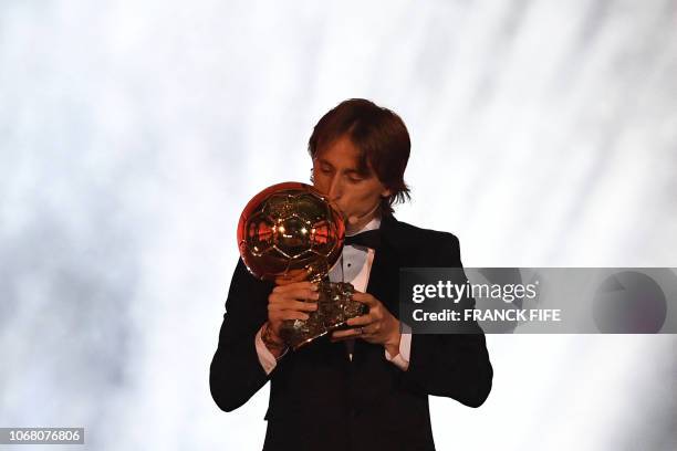 Real Madrid's Croatian midfielder Luka Modric kisses the trophy after receiving the 2018 Men's Ballon d'Or award for best player of the year during...