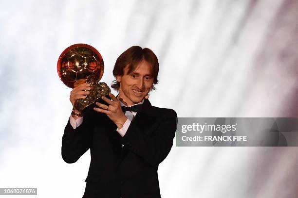 Real Madrid's Croatian midfielder Luka Modric kisses the trophy after receiving the 2018 Men's Ballon d'Or award for best player of the year during...