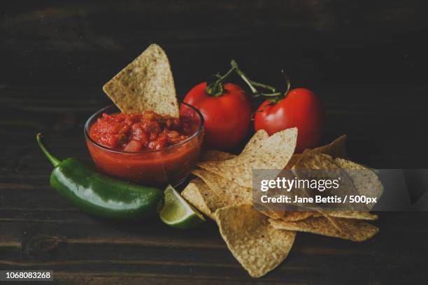 salsa and chips on wooden table - salsa sauce stock pictures, royalty-free photos & images