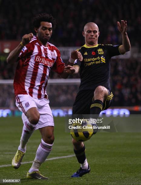 Paul Konchesky of Liverpool in action with Jermaine Pennant of Stoke City during the Barclays Premier League match between Stoke City and Liverpool...