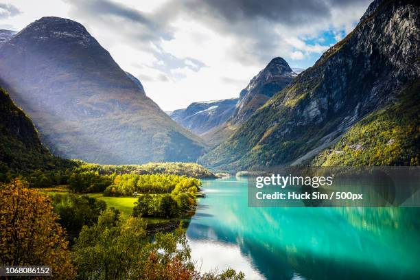 clouds and sun beams over fjord - norwegen 個照片及圖片檔