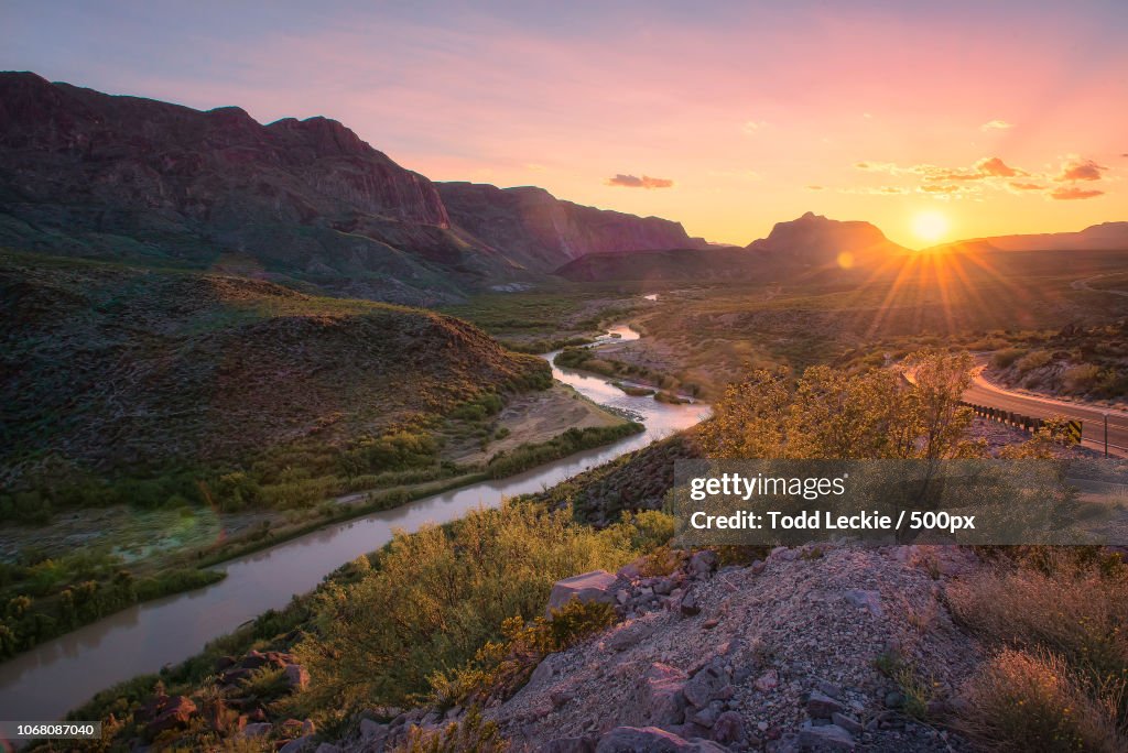 Landscape with winding river at sunset