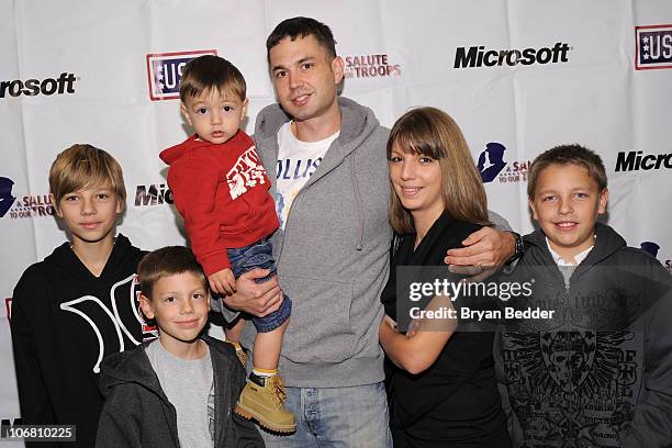 Wounder warrior and family pose during Microsoft and the USO's "A Salute To Our Troops" Wounded Warrior Luncheon at Hard Rock Cafe - Times Square on...