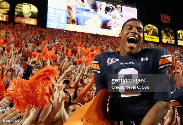 Quarterback Cameron Newton of the Auburn Tigers celebrates with fans after their 49-31 win over the Georgia Bulldogs at Jordan-Hare Stadium on...