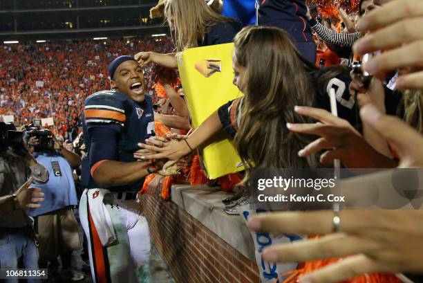 Quarterback Cameron Newton of the Auburn Tigers celebrates with fans after their 49-31 win over the Georgia Bulldogs at Jordan-Hare Stadium on...