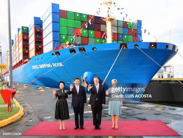 China's President Xi Jinping and Panama's Juan Carlos Varela wave flanked by First Ladies Peng Liyuan and Panama's Lorena Castillo in front of...