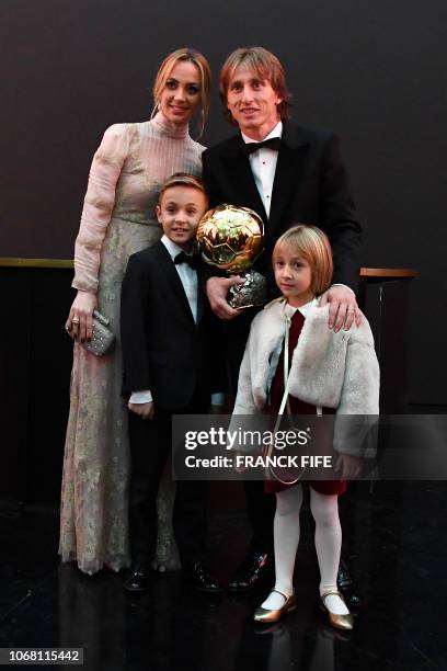 Men's Ballon d'Or award for best player of the year's Real Madrid's Croatian midfielder Luka Modric pose with his wife Vanja , his son Ivano and his...