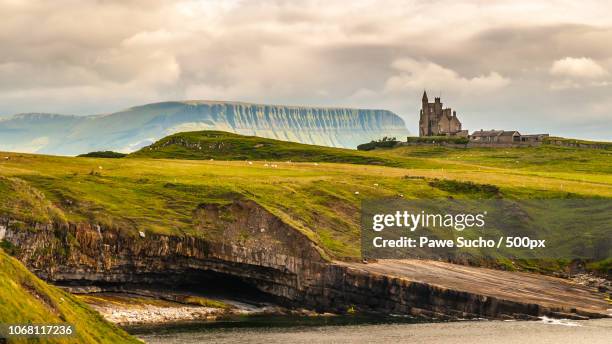 scenic view of landscape with classiebawn castle - irisch stock pictures, royalty-free photos & images